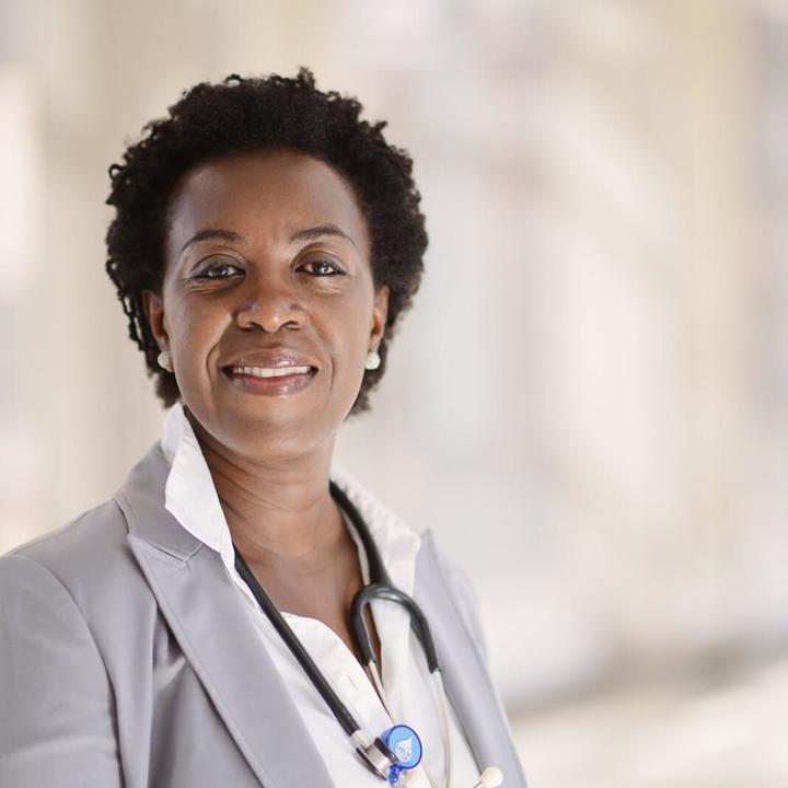Female wearing a gray suit and stethoscope